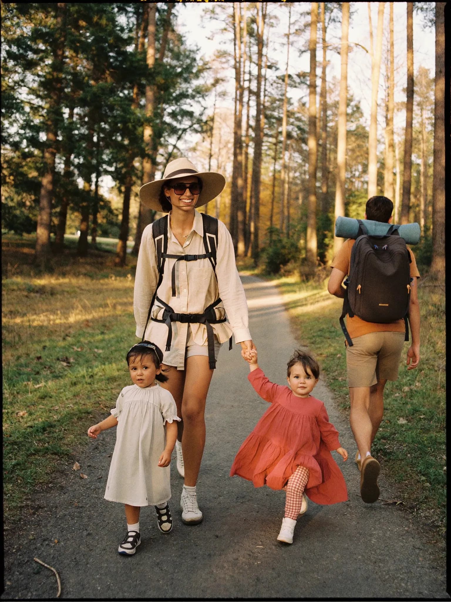 Jong gezin met twee kinderen wandelend over een bospad